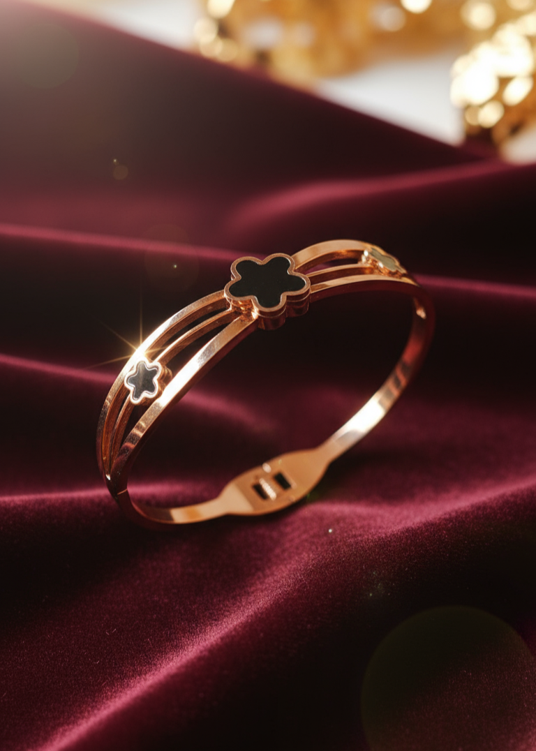 rose Gold bracelet with floral design on a red fabric background