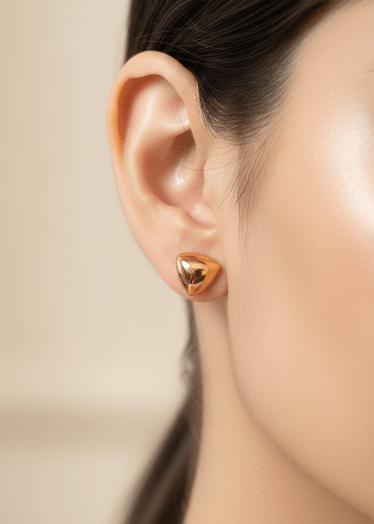 Triangular Gold Stud Earrings worn by a girl