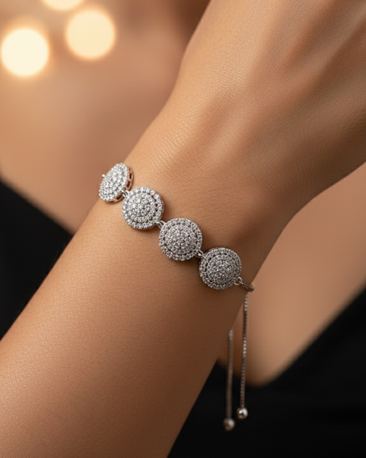 Silver bracelet with round, diamond-studded beads on a blurred background
