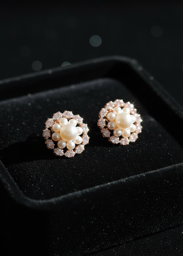 Pair of pearl stud earrings on a black background
