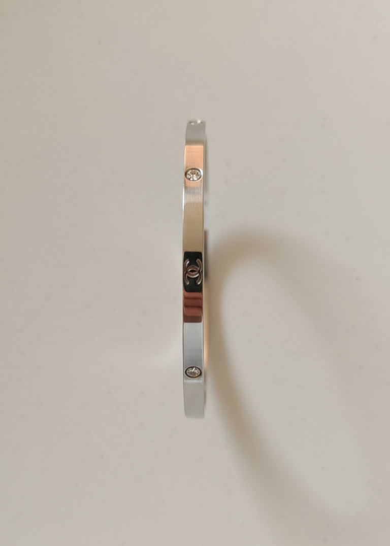 Silver bracelet on a light gray background