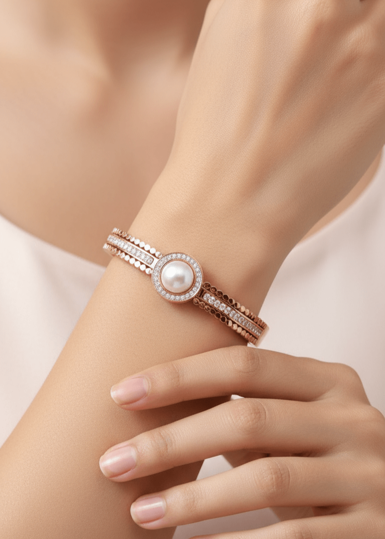 Close-up of a hand wearing a pearl bracelet on a blurred background