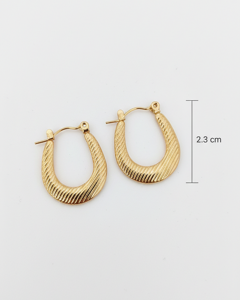 Gold hoop earrings with textured design on a light gray background